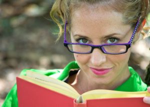Woman in green shirt reading a book